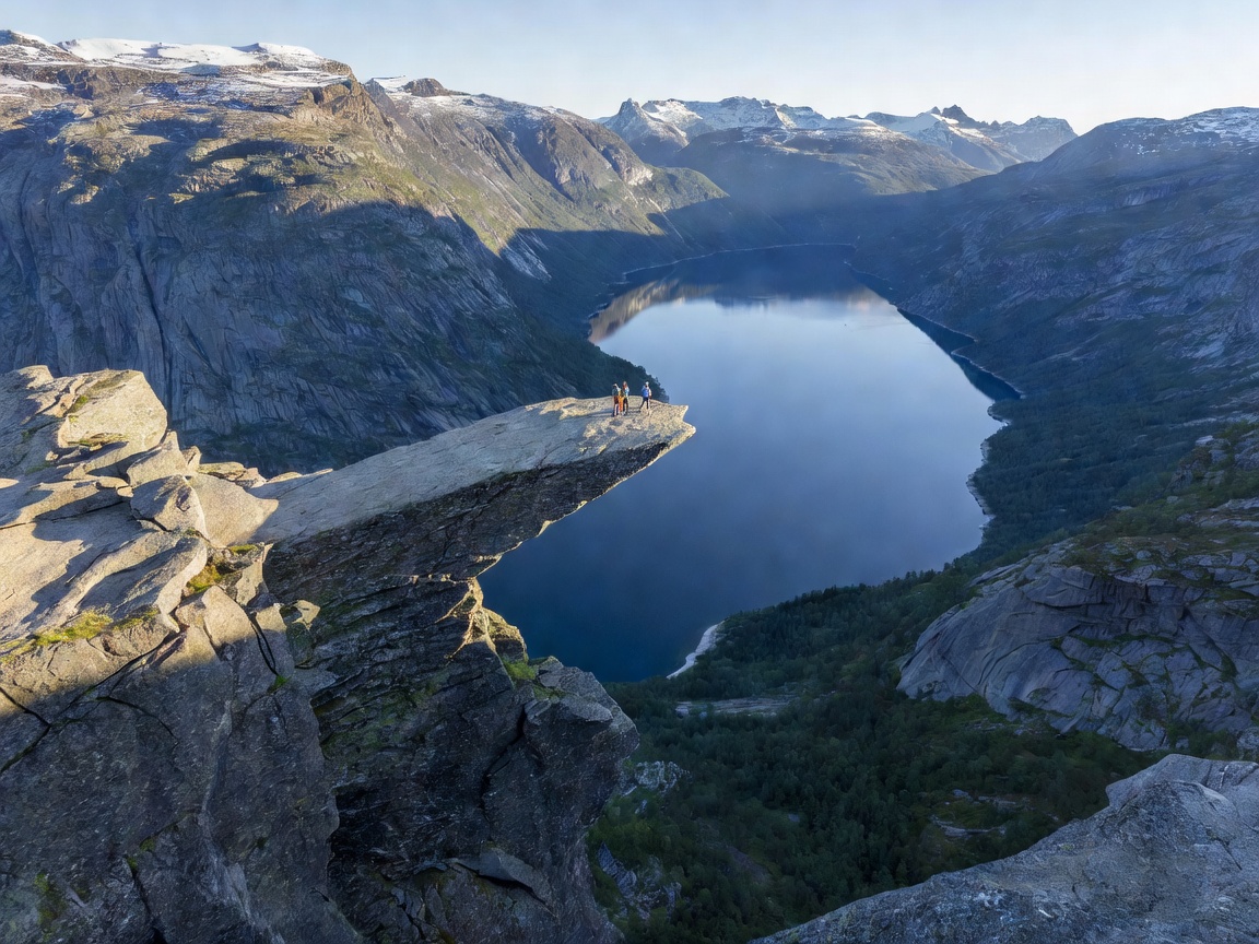 Granite rock formation Trolltunga jutting out horizontally over Lake Ringedalsvatnet